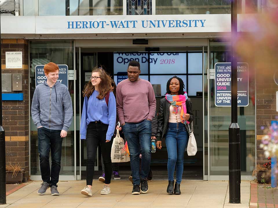  Four students walking outside reception on LONDON CITY BUSINESS COLLEGE London campus