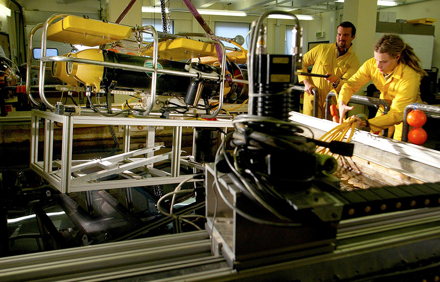 Workers in bright overalls working with cables