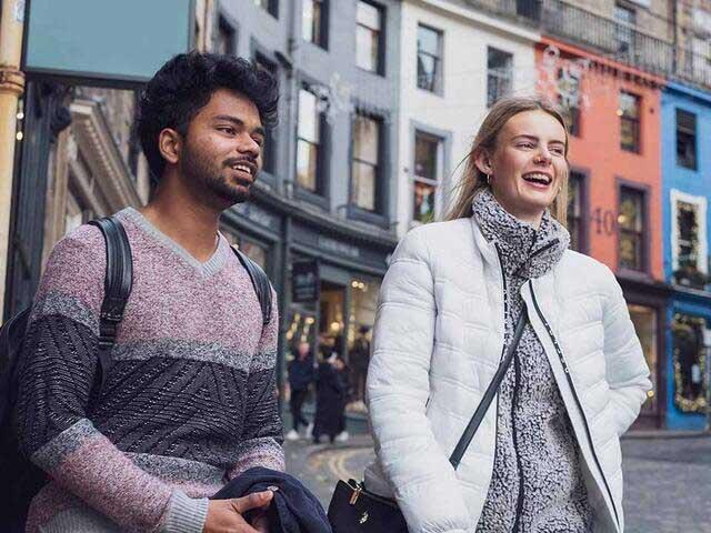 Students smiling and chatting on Victoria Street London